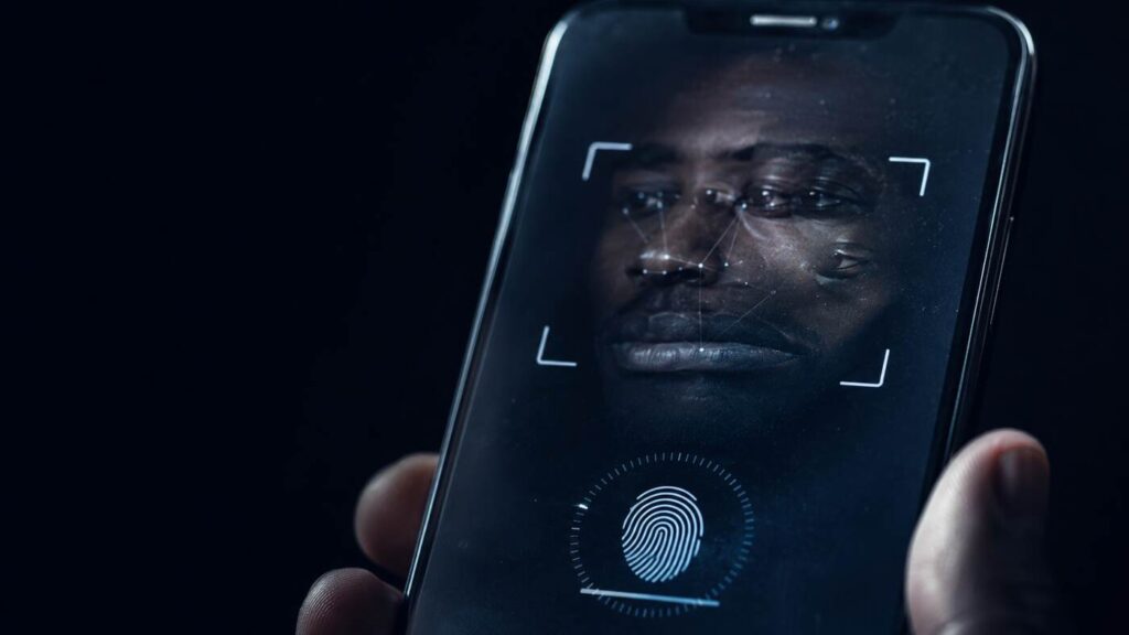 interpol-african-cyberthreat-assessment-2026-synthetic-identities A biometric verification prompt on a phone screen with an unresolved facial reflection