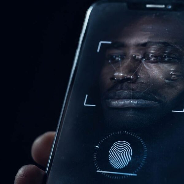 interpol-african-cyberthreat-assessment-2026-synthetic-identities A biometric verification prompt on a phone screen with an unresolved facial reflection