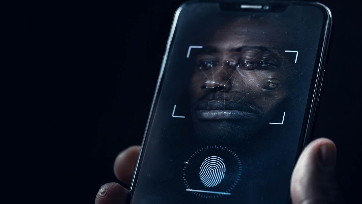 A biometric verification prompt on a phone screen with an unresolved facial reflection 